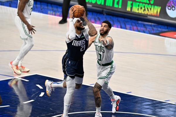 Dallas Mavericks center Daniel Gaffor<em></em>d (21) drives against Boston Celtics forward Jayson Tatum (0)  during the second half of game four of the 2024 NBA Finals at American Airlines Center.