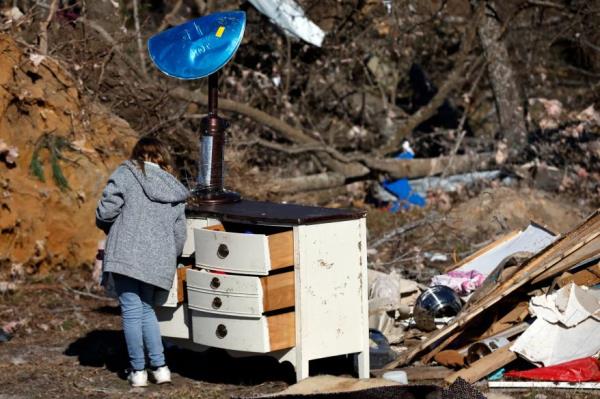 A woman looks through her dresser for perso<em></em>nal items as she tried to recover house items after the tornado left Central Alabama destroyed on Jan. 14, 2023 in Marbury, Ala.