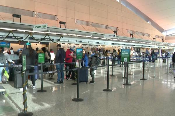 People line up at an airport terminal.