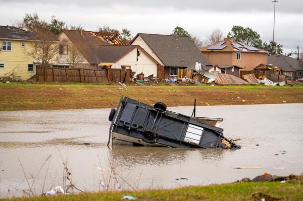 A camping trailer sits in a retention pond wher<em></em>e a tornado was reported to pass along Mickey Gilley Blvd., near Fairmont Parkway, on Jan. 24, 2023, in Pasadena, Texas. 