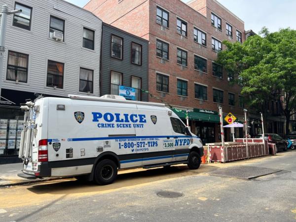 An NYPD van waits outside the Brooklyn home wher<em></em>e a woman was stabbed Saturday.