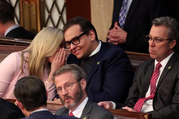 Rep. Marjorie Taylor Greene (R-GA) shares a laugh in the back row of the House Chamber with newly elected freshman Rep. George Santos