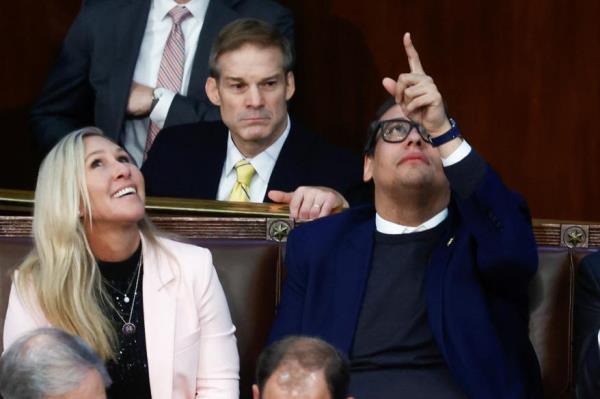 Rep. Marjorie Taylor Greene (R-GA) shares a laugh in the back row of the House Chamber with newly elected freshman Rep. George Santos