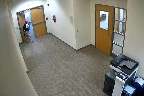 The shooter is seen pointing their rifle down a hallway of the Covenant Church on March, 28, 2023.