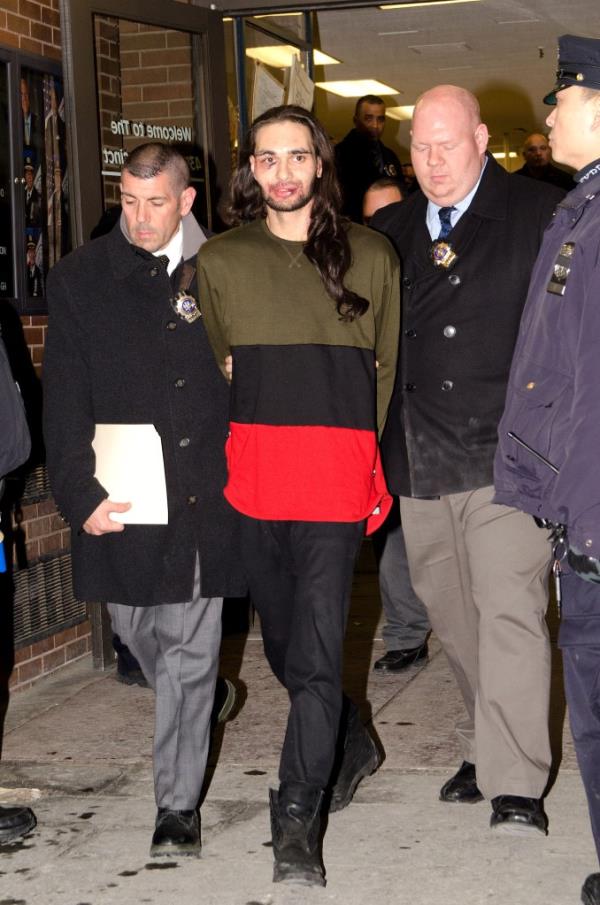 Police walk Jose Go<em></em>nzalez out of a police precinct after his arrest. 