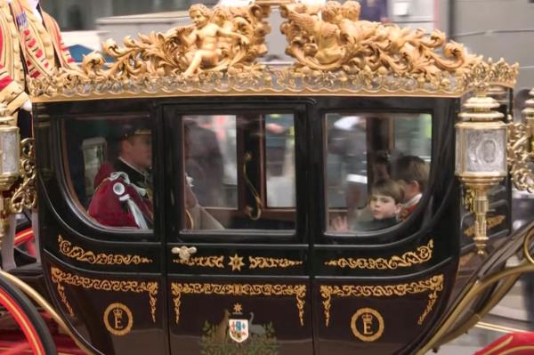 Louis gives a wave as he sits alo<em></em>ngside his siblings and parents following the co<em></em>nclusion of the ceremony. 
