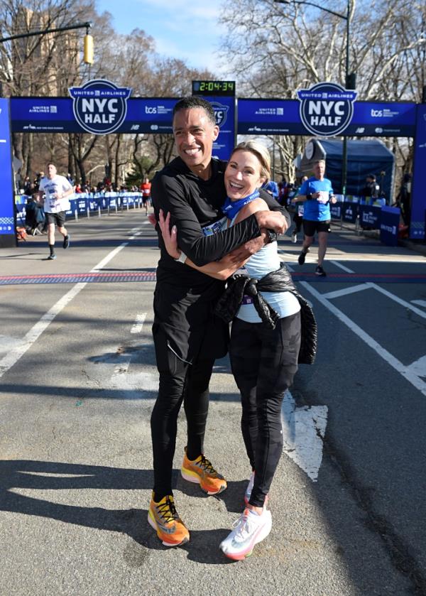 TJ Holmes and Amy Robach celebrate as they cross the finish line.