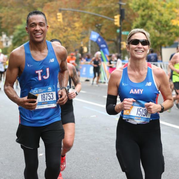 Amy Robach and T.J. Holmes run through Harlem in the 2022 New York City Marathon.