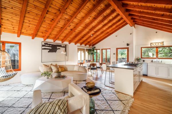 Inside, the home features vaulted wood ceilings.