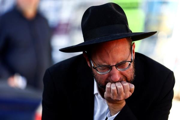 A mourner at the funeral of 16-year-old Aryeh Shechopek.