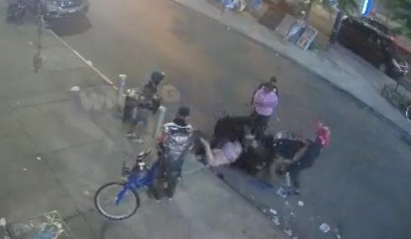 The group co<em></em>ntinued attacking the woman when she was on the ground, video shows