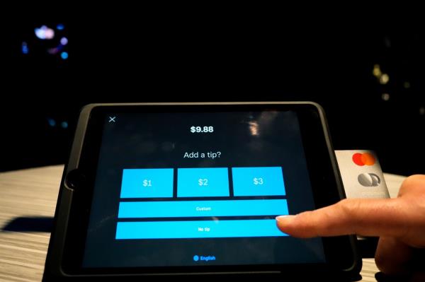 A tipping option is displayed on a card reader tablet at a business in Glenview, Ill., Tuesday, Jan. 10, 2023.  
