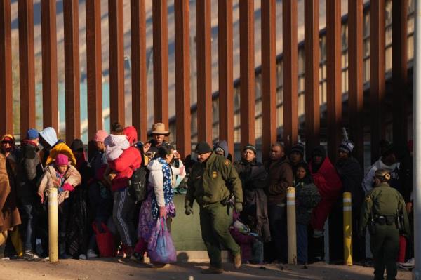 Migrants line up to be transported by U.S. Customs and Border Protection officers after they crossed the U.S.-Mexico Border at the Rio Grande from Ciudad Juarez, Mexico to El Paso, Texas, on Dec. 22.