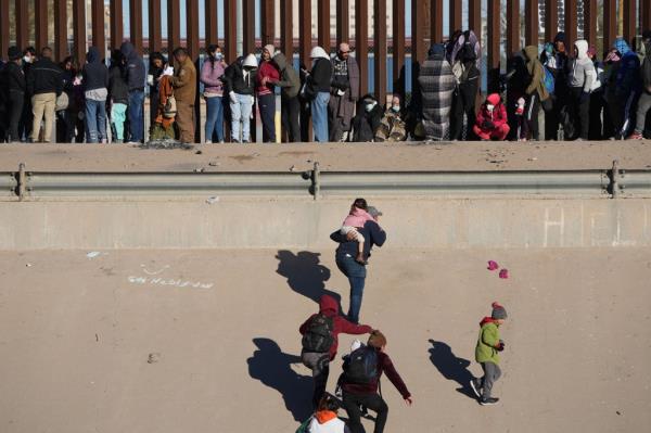 Migrants cross the Rio Grande River at the U.S.-Mexico border.