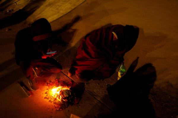 Asylum-seeking migrants on the Mexican side of the border gather around a fire near the Rio Grade river on Dec. 21.