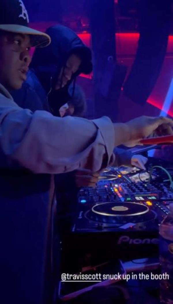 Travis Scott behind DJ booth