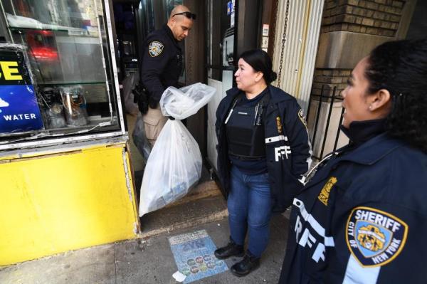 Task force members at the door of one of the smoke shops.