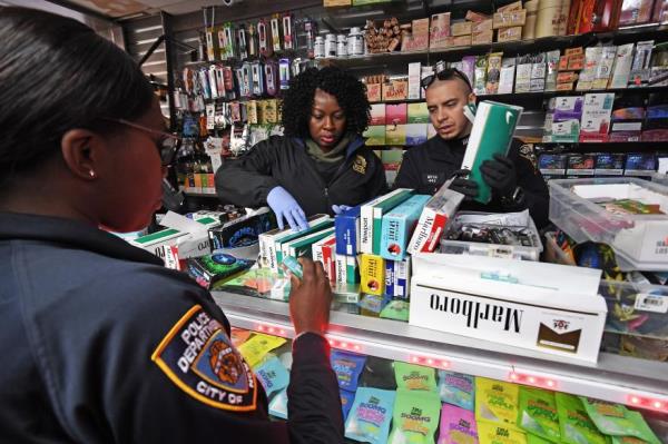 Officers go through store inventory during raids in Washington Heights.