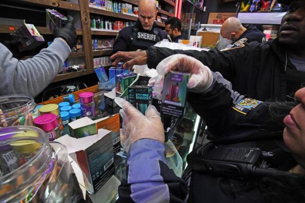 Officers collect evidence during Monday's raids in Washington Heights.