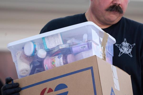 An officer carries out possessions of the murdered students.