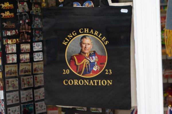 A photo of King Charles in a formal uniform with his  coro<em></em>nation logo on it. 