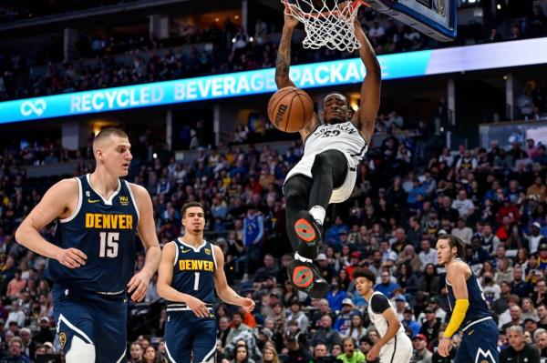Nic Claxton dunks during the Nets' win over the Nuggets on March 12.