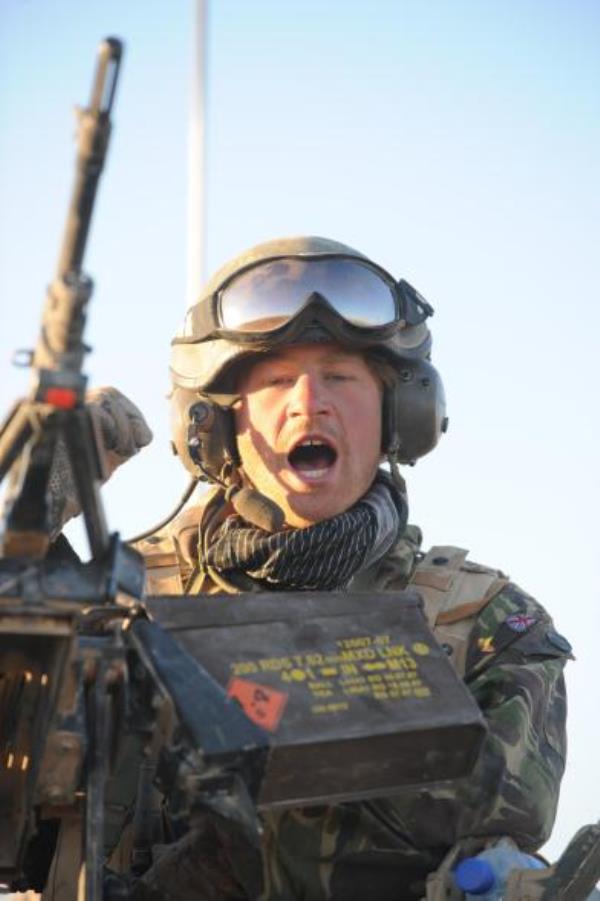 Prince Harry speaks on the radio from the turret of his Spartan armored vehicle in the desert in Afghanistan.