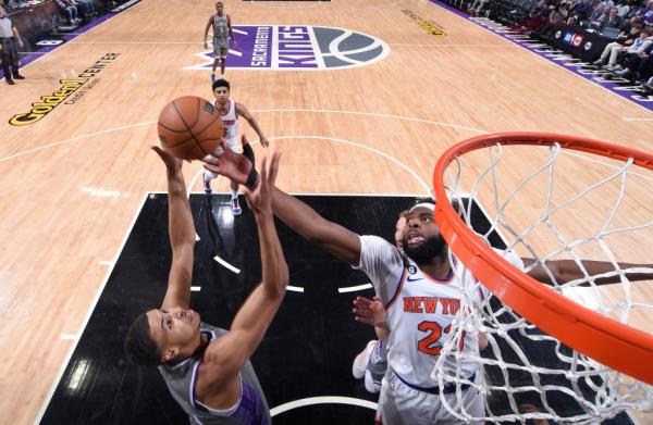 Mitchell Robinson #23 of the New York Knicks and Keegan Murray #13 of the Sacramento Kings fight for the rebound