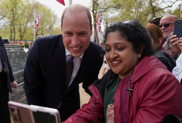 Britain's Prince William poses for a selfie as he meets well-wishers during a walka<em></em>bout on the Mall.