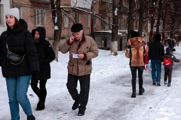 Ukrainian civilians walking on a snowy street