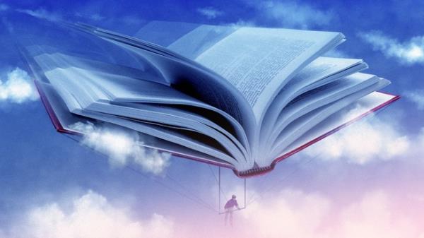 A person using a book as a hang glider