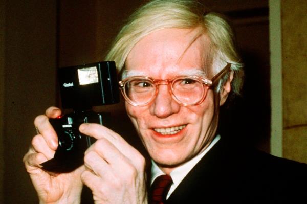 Artist Andy Warhol smiles in New York n 1976.