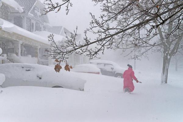 A woman walks through the blizzard.