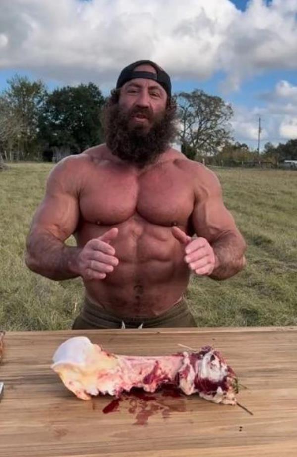 Liver King a<em></em>bout to eat some raw meat.