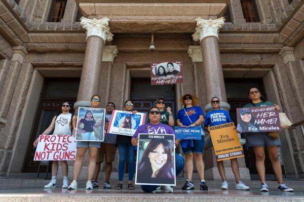 Maggie Mireles, center, kneels at the Texas State Capitol with other family members for the victims of the Uvalde school shooting .