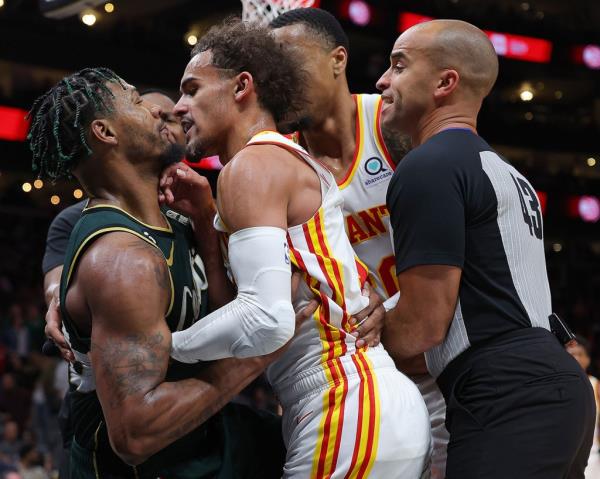 Marcus Smart #36 of the Boston Celtics and Trae Young #11 of the Atlanta Hawks get into an altercation as they both fall to the floor during the fourth quarter at State Farm Arena on March 11, 2023 in Atlanta, Georgia.   