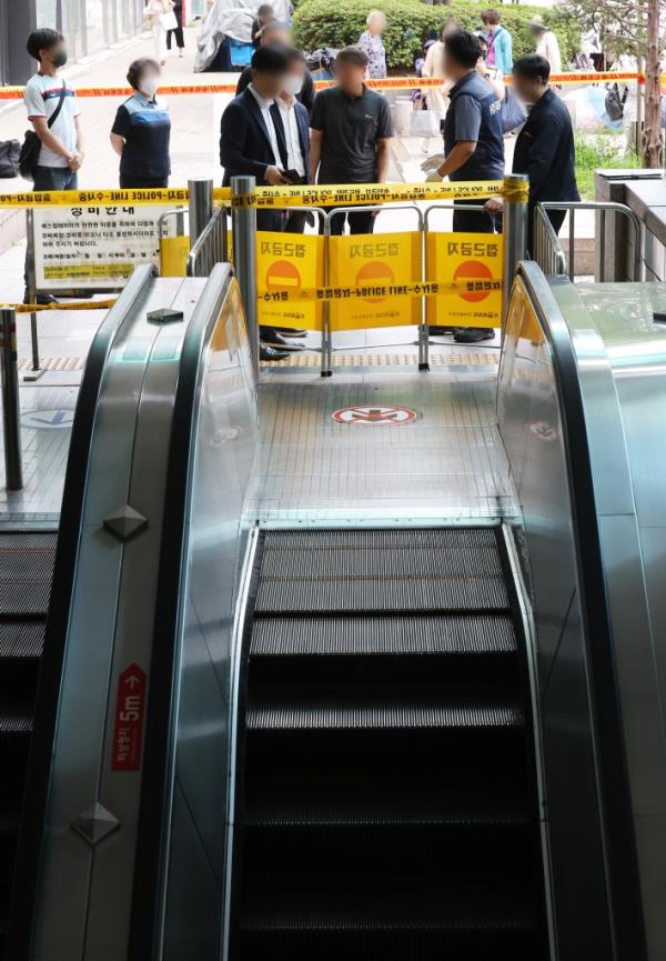 A police probe is under way at an upward escalator leading to an exit at Sunae Subway Station in Seongnam, south of Seoul, on June 8, 2023
