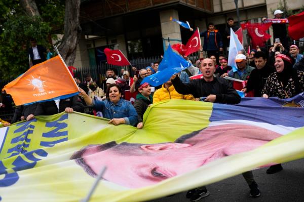 Supporters of the Turkish President Recep Tayyip Erdogan shout slogans outside his house.
