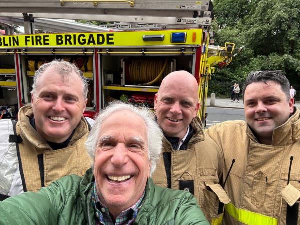 Winkler selfie with firefighters.