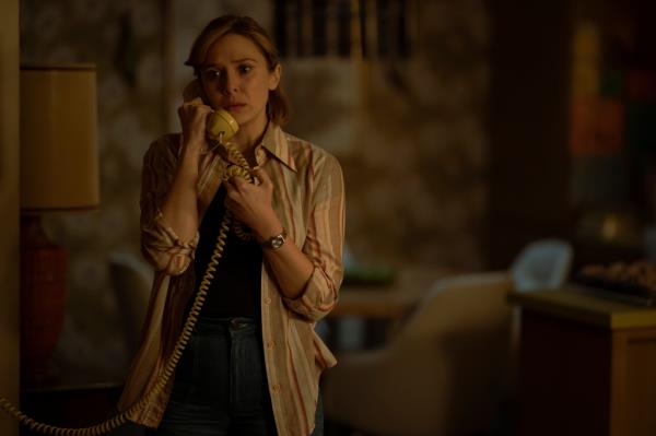 Elizabeth Olsen on the phone looking worried. 