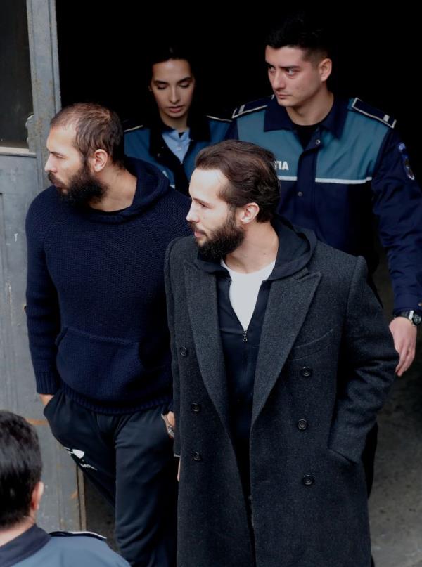 Andrew and Tristan Tate leaving court in Romania after Monday's hearing.