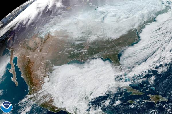 Satellite image made available by NOAA shows weather systems across North America on Saturday, Dec. 24, 2022, at 12:06 p.m. EST. A battering winter storm knocked out power to hundreds of thousands of homes and businesses across the United States on Saturday, left millions more to worry a<em></em>bout the prospect of further outages and crippled police, fire departments and an airport in snow-blown New York state. 