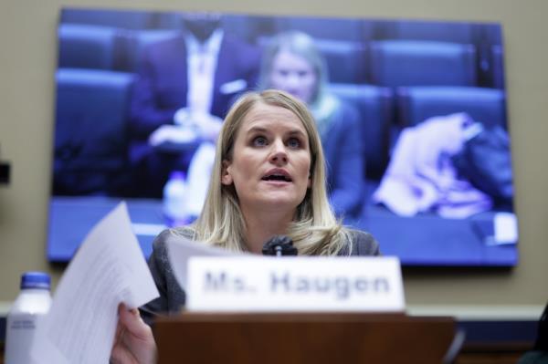 Frances Haugen a a microphone in front of a House Committee