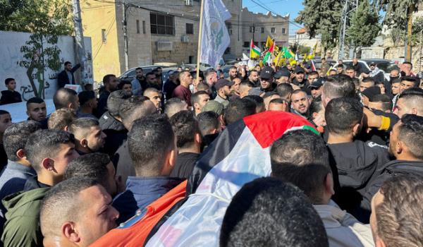 Mourners carry the body of 38-year-old Palestinian, Ahmad Assi, who was killed in an Israeli settler raid, during his funeral near Salfit in the Israeli-occupied West Bank December 3, 2023. (REUTERS)