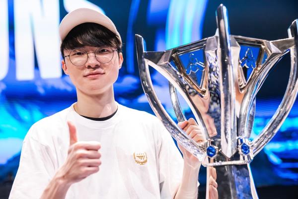 Lee Sang-hyeok, better known as Faker, holds the 2023 League of Legends World Champio<em></em>nship trophy following his final match victory in Busan, South Korea, on Nov. 19. (SK Square)