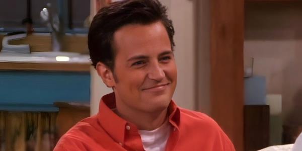 Chandler smiles while sitting in his apartment.