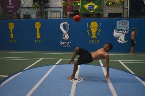 Children play soccer at a field in the Morro favela of Rio de Janeiro, Brazil, on December 08 , 2022