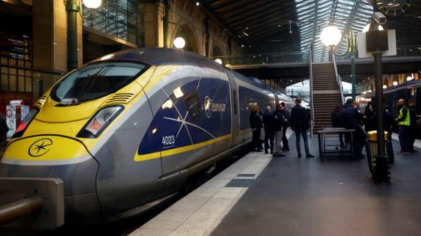 People stand on a platform at the Eurostar terminal at Gare du Nord train station, as an unexpected strike by French workers at Eurotunnel, the undersea l<em></em>ink between Britain and co<em></em>ntinental Europe, interrupted cross-Channel rail traffic, threatening the Christmas holiday plans of many travelers, in Paris, France, December 21, 2023. REUTERS/Sarah Meyssonnier