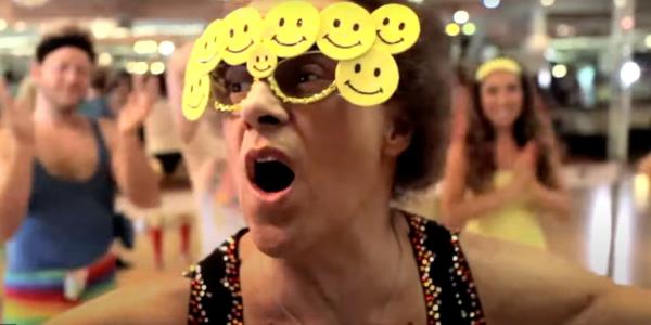 Richard Simmons wearing glasses with happy faces on them in Workout Wednesday Light Dumbbell Workout for Arms, Chest, Shoulders and Back.